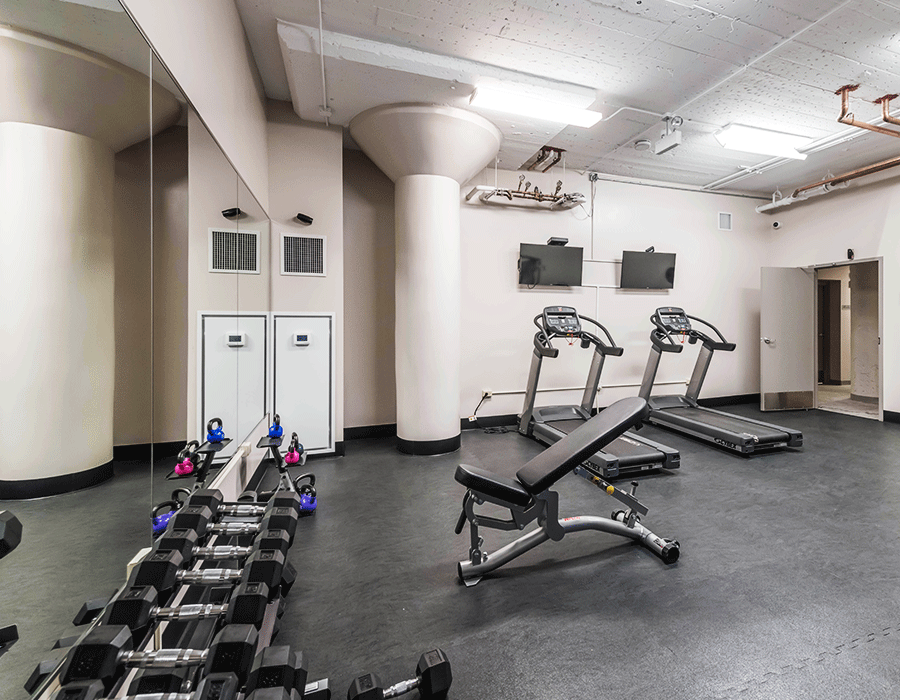 apartment fitness center with crossfit machine and treadmills 