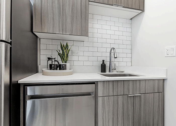 Subway tile backsplash in modern studio apartment kitchen